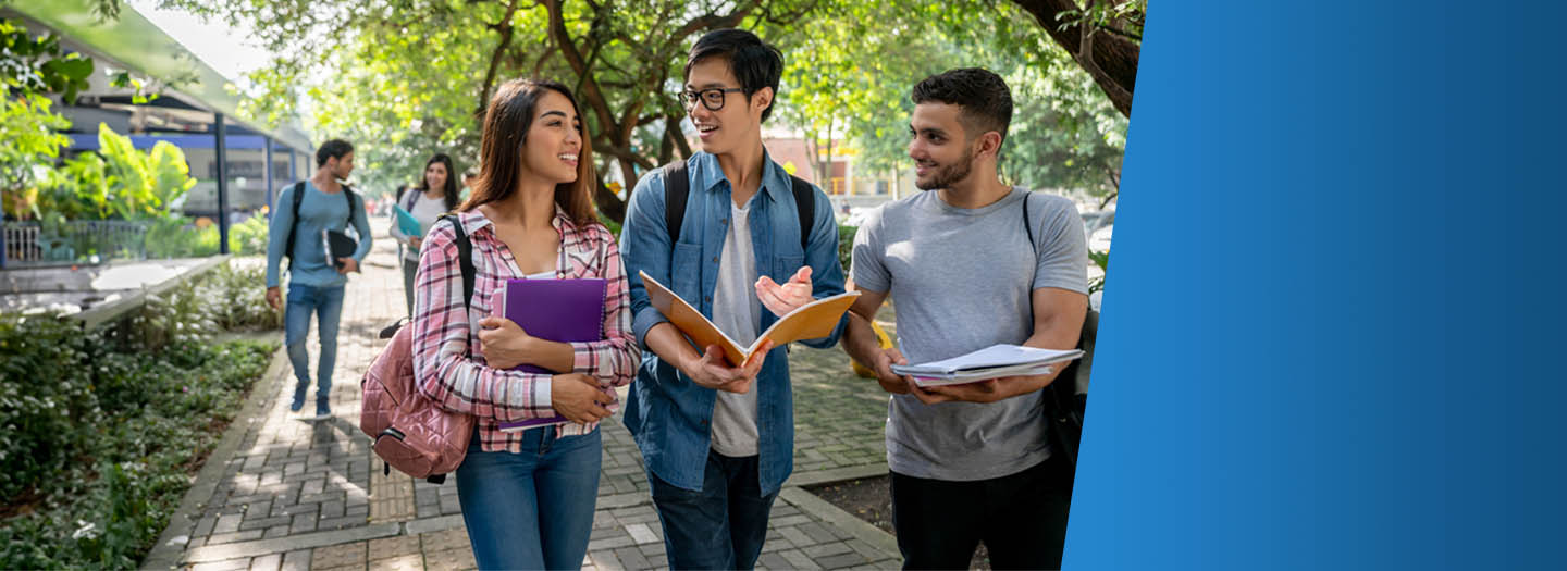 Three students walking on college campus